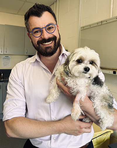 Dr Benoit Cup holding Coco the dog